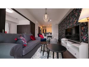 a living room with a couch and a tv at Hotel Best Price Kochi - Vacation STAY 17542v in Kochi