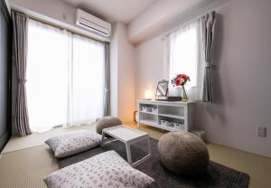 a living room with two chairs and a table at Hotel Best Price Kochi - Vacation STAY 17542v in Kochi +18 photos