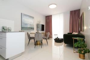 a living room with a couch and a table at Gorgeous 1 bedroom apt , J Tower in Jerusalem