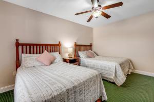 a bedroom with two beds and a ceiling fan at Bon Air Unit 4032 in Gatlinburg