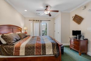 a bedroom with a bed and a ceiling fan at Bon Air 2011 in Gatlinburg