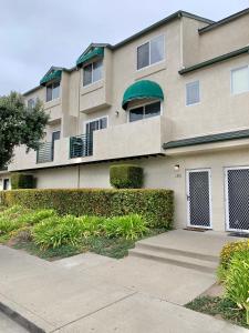 a apartment building with a sidewalk in front of it at Pismo Beach Rental in Pismo Beach