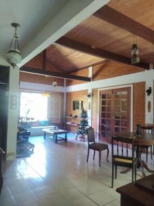 a living room with a table and a christmas tree at Sítio Recanto Amado. in Santa Teresa