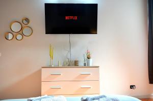 a bedroom with a dresser and a tv on the wall at Domus Cavour in Civitavecchia +33 photos