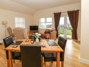 a dining room with a wooden table and chairs at Coquet in Longframlington