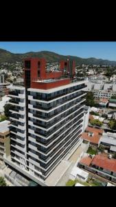 un gran edificio blanco en una ciudad con edificios en Edificio Leonardo departamento 16 en Villa Carlos Paz