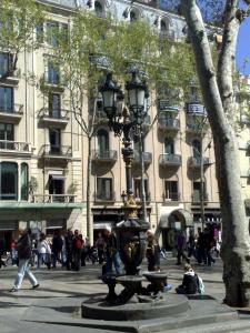 a street light in front of a large building at Hostal Capitol Ramblas in Barcelona