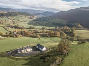 an aerial view of a house in the middle of a field at Tyn Llwyn in Llangollen