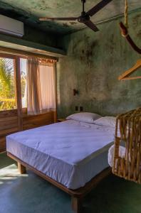 a bedroom with a large bed with a blue blanket at COCOS HOTEL in Zipolite