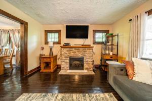 a living room with a fireplace and a tv at Cheerful 3 BR. 2 Bath, Spacious Family Home in Akron