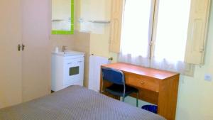 a small bedroom with a desk and a sink at Hostal Capitol Ramblas in Barcelona