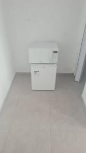 a white box sitting on the floor in a room at Pousada Félix in Curitiba