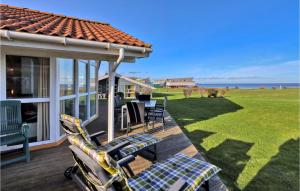 a porch with chairs and a view of the ocean at Strandblick 31 in Schönhagen