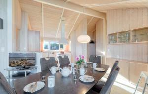 a dining room with a table and chairs in a kitchen at Strandblick 31 in Schönhagen