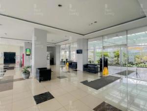 an empty lobby with a large room with glass walls at Room Apartemen by GIANDARA in Sayang
