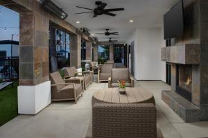 a patio with chairs and a table and a fireplace at Courtyard by Marriott San Diego Carlsbad in Carlsbad