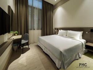 Voodi või voodid majutusasutuse Hutton Central Hotel Managed by The Ascott Limited toas