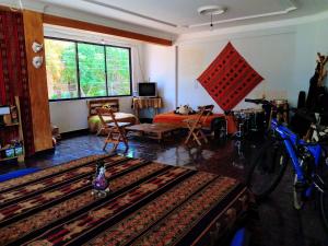 a living room with a bed and a bike in it at La Casita Feliz...!!! in Cochabamba