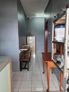 a kitchen with a table and a counter in a room at DK Guest Room in Kota Kinabalu