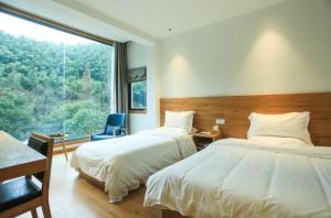 Ένα ή περισσότερα κρεβάτια σε δωμάτιο στο Villa EN Emerald Valley, Huangshan