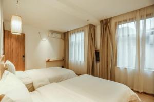 Ένα ή περισσότερα κρεβάτια σε δωμάτιο στο Villa EN Emerald Valley, Huangshan