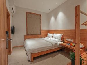 Ένα ή περισσότερα κρεβάτια σε δωμάτιο στο Villa EN Emerald Valley, Huangshan