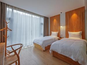 Ένα ή περισσότερα κρεβάτια σε δωμάτιο στο Villa EN Emerald Valley, Huangshan