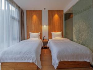 Ένα ή περισσότερα κρεβάτια σε δωμάτιο στο Villa EN Emerald Valley, Huangshan