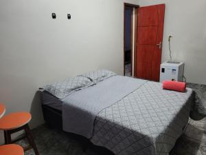 a bedroom with a bed with a red pillow on it at Olga Moreira 01 - inclui garagem in Paragominas