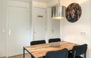 a dining room with a wooden table and chairs at 2 Bedroom Lovely Home In Heinkenszand in Heinkensand