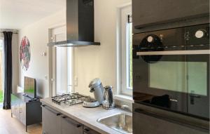 a kitchen with a sink and a stove top oven at 2 Bedroom Lovely Home In Heinkenszand in Heinkensand +37 photos
