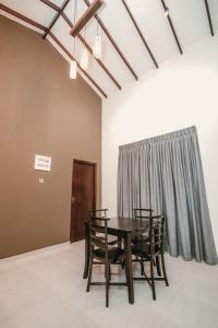 a table and chairs in a room with a window at Negombo 146 Homestay in Negombo