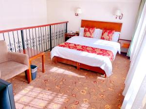 Postel nebo postele na pokoji v ubytování King Parkview Hotel