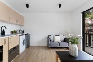 a kitchen and living room with a couch and a table at Skyline Suite in Queenstown