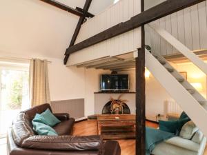 a living room with a couch and a loft at Stable Cottage in Whitby