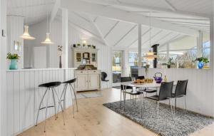 a kitchen and dining room with a table and chairs at Beautiful Home In Jgerspris With Wifi in Jægerspris