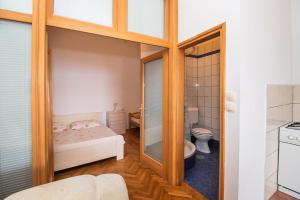 a small bathroom with a bed and a toilet at Apartments More Sunce in Seline +69 photos