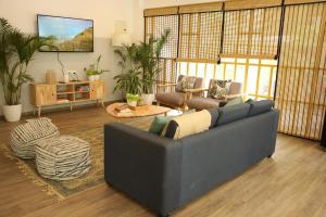 a living room with a couch and a table at Olive Indiranagar - By Embassy Group in Bangalore