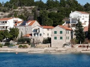 a group of houses next to a body of water at Apartment Island memories in Prvić Šepurine