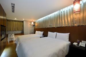 Giường trong phòng chung tại Hua Da Hotel- Nanxi