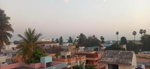 a view of a city with buildings and palm trees at Uthamar Illam in Tiruchchirāppalli +11 photos