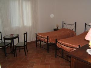 a bedroom with a bed and a table and chairs at Bel Sit in Bologna