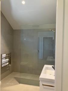 a bathroom with a glass shower and a sink at The Quarters Unit 1 - Lake Tekapo in Lake Tekapo