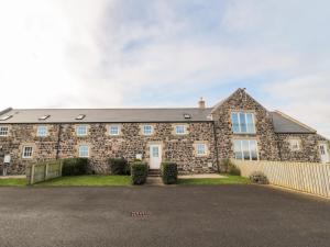 a large brick house with a driveway at Low Croft in Alnwick