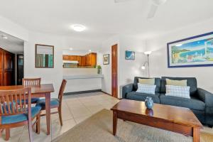 a living room with a couch and a table at Fuller Holidays-Unit Pacific in Byron Bay