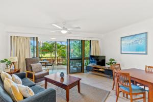 a living room with a couch and a table at Fuller Holidays-Unit Pacific in Byron Bay