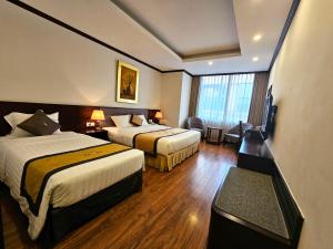 Llit o llits en una habitació de Lenid Hotel Tho Nhuom