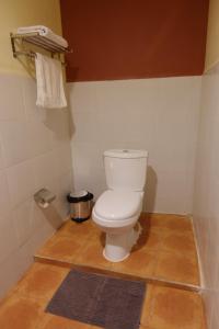 a bathroom with a white toilet in a room at Sunset INN by Pro-Ema in Dili +21 photos