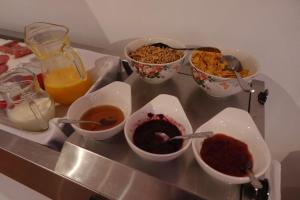 a tray with four bowls of food on a table at Sunset INN by Pro-Ema in Dili