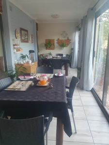 a dining room with a table and chairs at DOTJJ B & B in Paarl